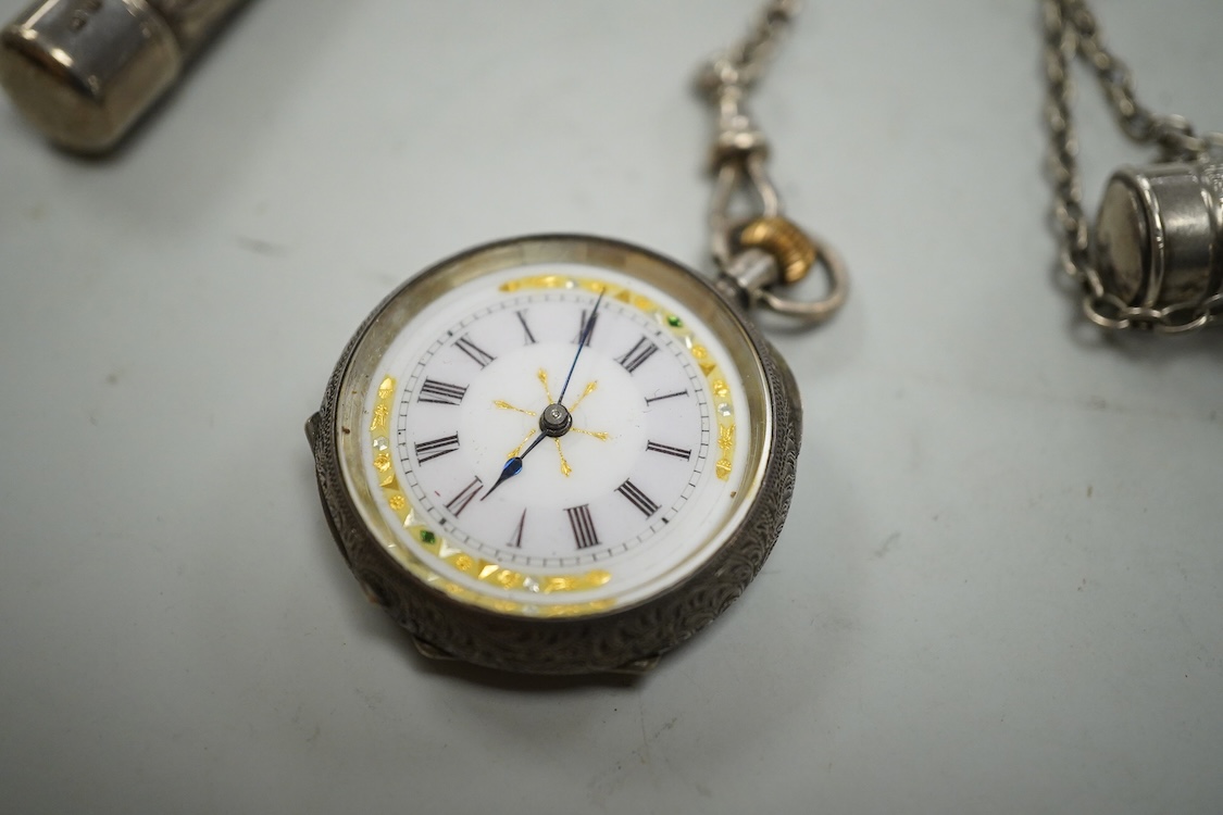 An Edwardian pierced silver chatelaine, by Samuel Jacob, London, 1902, with three accoutrements to include two silver cases and a enamelled fob watch, overall length 34cm.